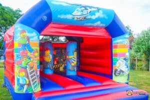 A colorful building block bouncy castle topped with building block art work, inviting play and imagination.