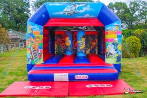 A whimsical bouncy castle constructed from building blocks, adorned with vibrant artwork.