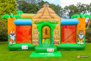 Inflatable jungle-themed bouncer featuring vibrant colors and animal designs, perfect for children's play and entertainment.