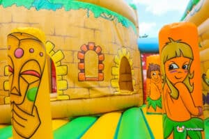 Jungle themed inflatable with colourful artwork.
