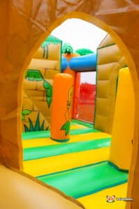 Orange inflatable biff and bash wobbler inside large inflatable play zone.