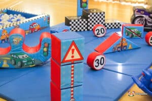Colorful inflatable play area featuring traffic-themed blocks, ramps, and balls, designed for children's fun and motor skill development.