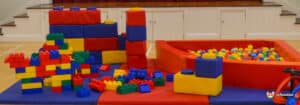 Colorful building blocks and a ball pit filled with vibrant balls create a fun play area for children.