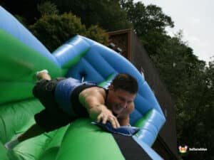 A man runs down a bungee run, enjoying the thrill of the inflatable attraction.