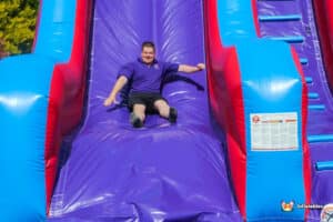 Adult sliding down the large slide having fun