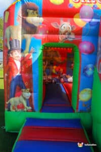 Entrance to bouncy castle, with ring master and circus theme