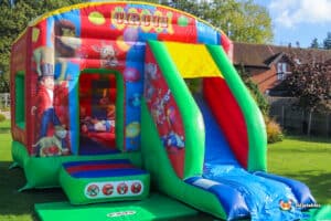 Vibrant circus theme inflatable with slide.