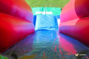 Steep slide on inflatable with blue slide sheet.