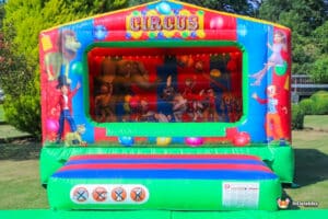 A vibrant bouncy castle adorned with a playful clown, creating a fun and lively environment for kids to enjoy.