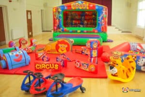 4. Bouncy castle with a circus theme, featuring a lion, elephant, and other animals, plus complementary soft play equipment.