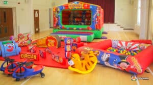 5. Circus-themed bouncy castle with a lion, elephant, and assorted animals, paired with matching soft play structures.
