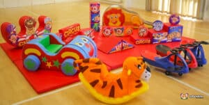 A circus-themed soft play area featuring colorful toys and play structures for children to enjoy.