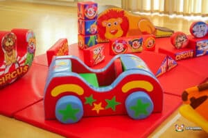 A vibrant circus-themed soft play area filled with various toys and play equipment for children's entertainment.