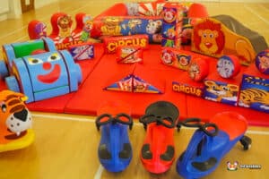 A lively soft play area designed with a circus theme, showcasing an array of toys for children to explore and play.