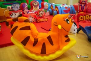 A playful circus-themed soft play area featuring an assortment of toys and structures for children's fun and engagement.