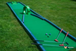 A vibrant miniature golf course featuring a green putting green labeled "Crazy Hole in 1" for fun and excitement.