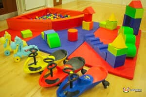A colorful play area featuring soft toys and a ball pool, inviting children to explore and enjoy creative playtime.