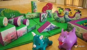 Play area at Dino Soft Play showcasing an assortment of toys and a cheerful toy dinosaur.