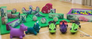 Engaging play area at Dino Soft Play, complete with toys and a playful soft toy dinosaur.