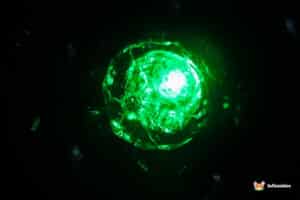 A glowing green crystal orb emitting bright light against a dark background, creating a mesmerizing, ethereal effect.