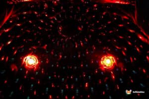 Interior of a dark, inflatable structure illuminated by vibrant red lights, creating a captivating, otherworldly atmosphere.