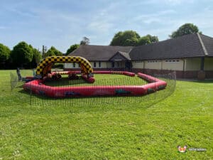 A colorful inflatable obstacle course in a field, designed as a race track for exciting outdoor challenges and races.