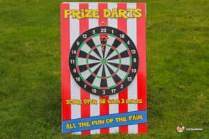 A colourful fairground darts game titled "Prize Darts" with striped background, inviting players to score over 50 points with three darts.