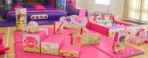 Bright soft play set with pink soft play shapes.