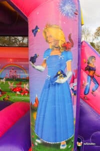 A vibrant bouncy castle adorned with a princess theme, perfect for children's parties and outdoor festivities.