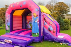 A cheerful bouncy castle decorated with princess illustrations, designed for children's enjoyment at a party or event.