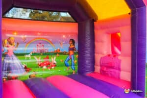 A whimsical bouncy castle designed with a princess theme, featuring bright colors and castle-like turrets for children's enjoyment.