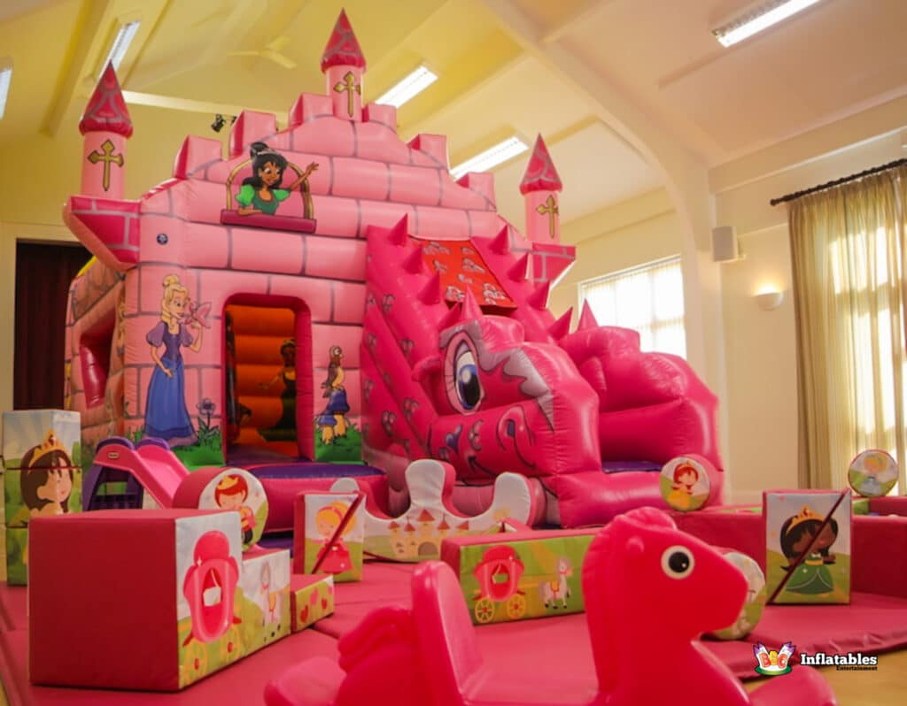 A playful pink castle with a slide and a soft play area, themed as a princess fairytale for young children.