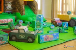 A playful scene of a large inflatable farm-themed play area, complete with colorful equipment for children to enjoy.