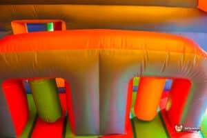 Colorful inflatable play structure with arches and pillars, designed for children to play and explore in a fun environment.