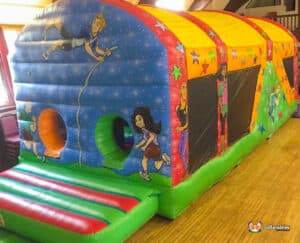 A colourful inflatable fun run 1 featuring vibrant graphics of children playing and exercising, with tunnels and slides.