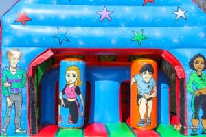 A colorful inflatable structure featuring playful cartoon characters in athletic attire, designed for fun and active play.