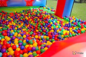 A vibrant ball pit filled with colorful balls in a bouncy inflatable structure, inviting fun and playtime for children.