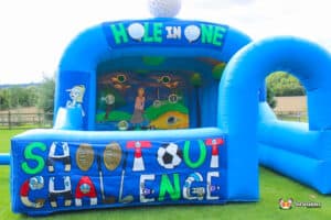 A large inflatable bouncer featuring a golf chipping challenge with a hole-in-one target for players to aim at.