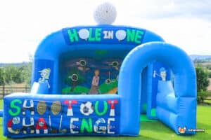 An inflatable bouncer showcasing a golf chipping challenge, complete with a hole-in-one target for participants to hit.