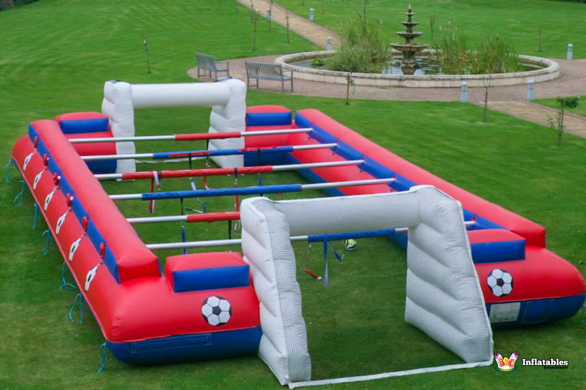 A vibrant inflatable soccer field designed for Human Table Football, complete with a goal for scoring.