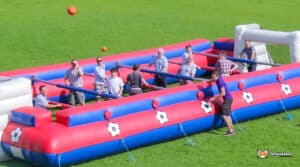 Inflatable soccer field set up for Human Table Football, featuring a large goal at one end.