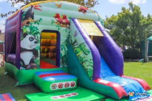 Brightly coloured bouncy castle with jungle animal theme ideal for birthday parties.