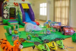 Jungle-themed play area featuring a slide and various toys for children to enjoy and explore.