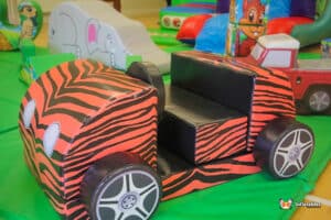 A zebra print car featured at a birthday party, set against a backdrop of colorful decorations and festive atmosphere.