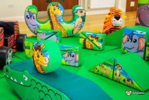 Colorful jungle-themed soft play area featuring various animal toys and play structures for children to enjoy.