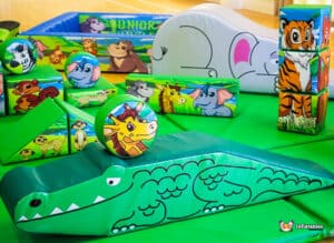 A colorful jungle soft play area filled with diverse toys and furniture, designed for children's play and exploration.