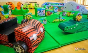 A lively jungle soft play space showcasing an assortment of toys and furniture, perfect for children's playtime adventures.