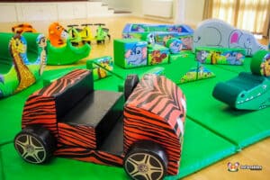 Colorful jungle soft play area filled with diverse toys and furniture, designed for children's fun and imaginative play.
