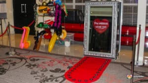 A Magic Mirror silver set on a red carpet, enclosed by a red rope, creating a stylish photo opportunity.