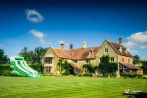 The Mammoth slide, a large inflatable slide featuring a vibrant green and white design, stands ready for fun.